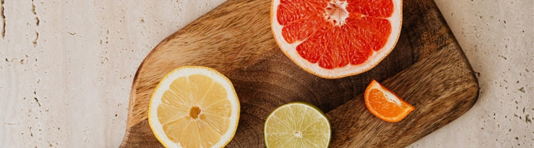 Wooden cutting board with fruits on top