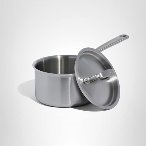 Stainless steel pot with lid on a white background