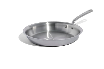 Stainless steel frying pan on a white background