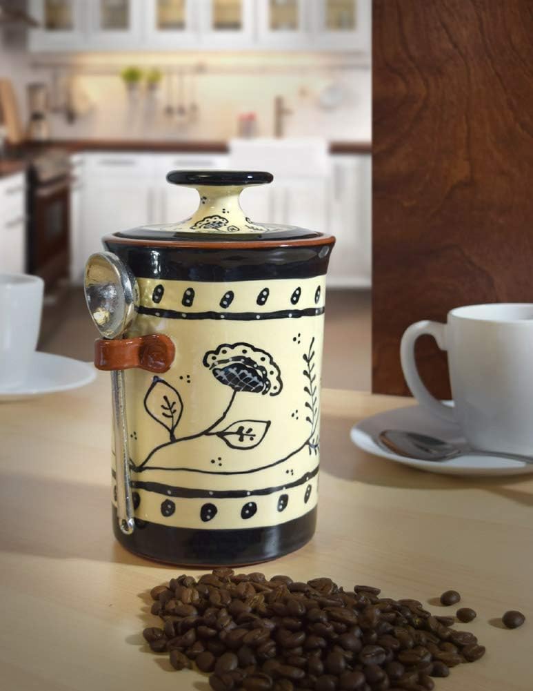 Decorative coffee grinder with coffee beans on a kitchen counter