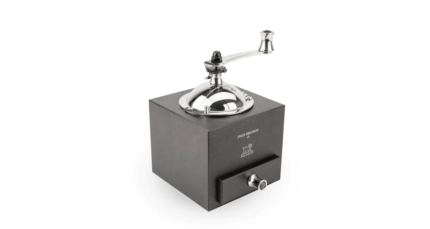 Manual coffee grinder with metallic top on a white background