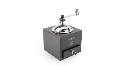 Manual coffee grinder with metallic top on a white background