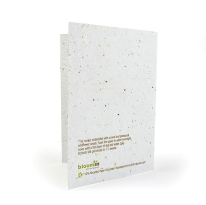 Seed paper card with text and 'bloomin' branding on a white background