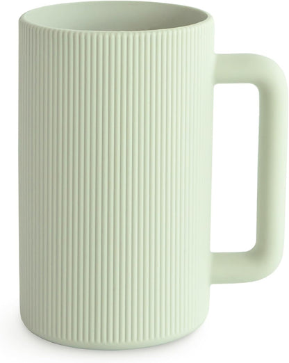 Light green mug with ribbed texture on a white background