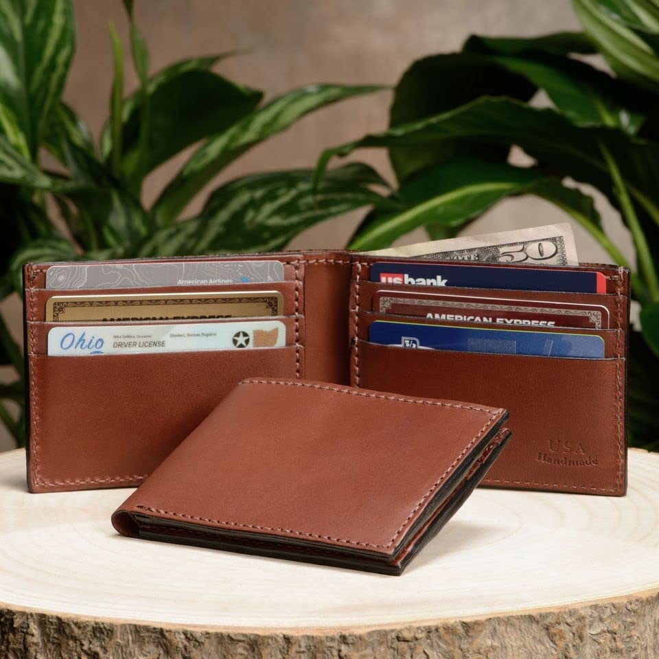 Brown leather wallet with cards on a wooden surface with plants in the background