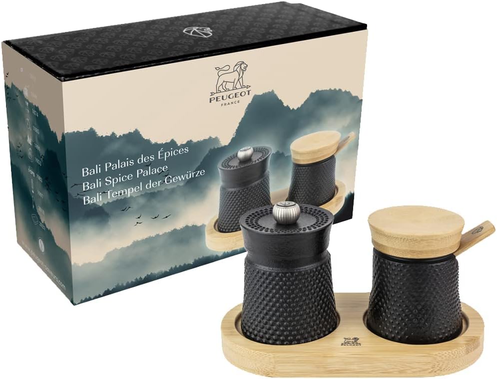 Peugeot spice set with black containers and wooden lids on a white background