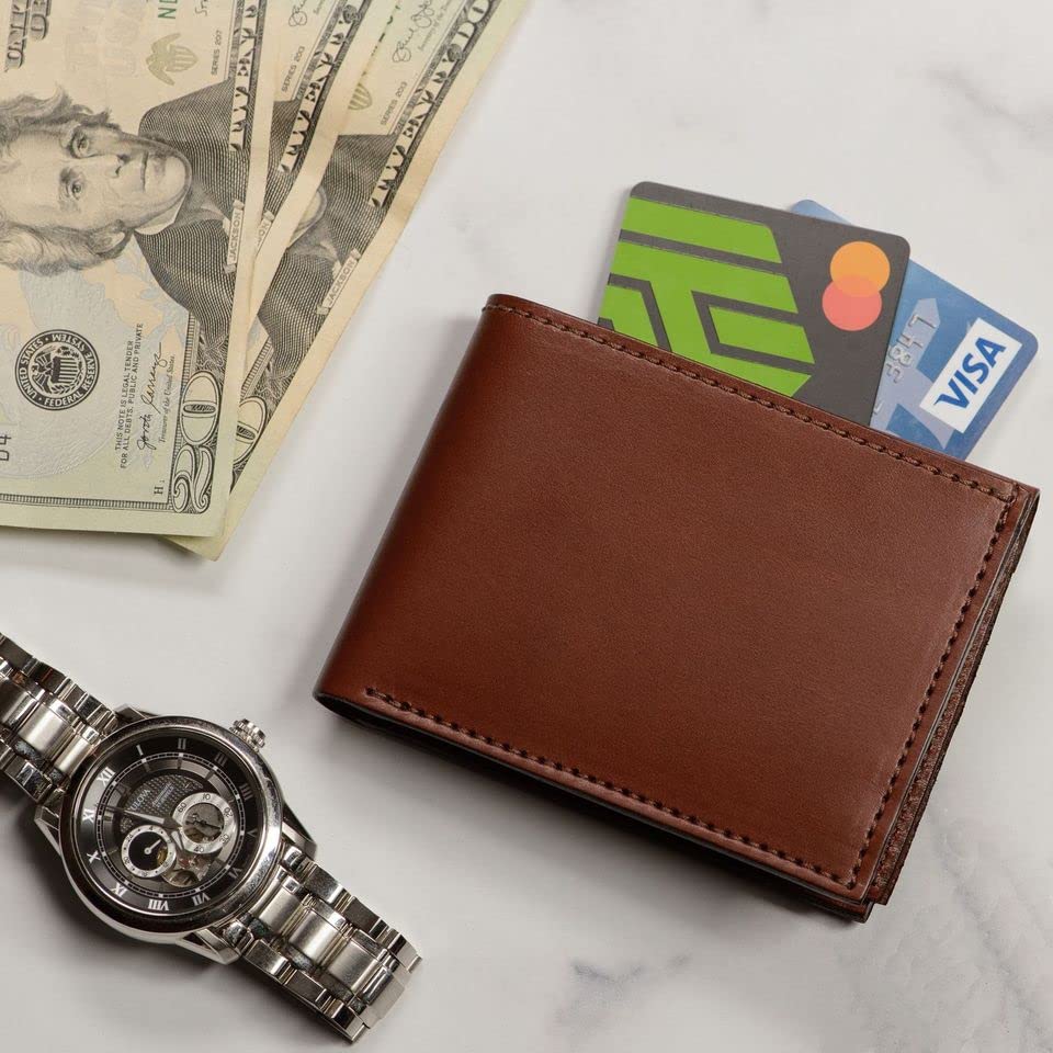 Brown leather wallet with cards, watch, and dollar bills on a light surface