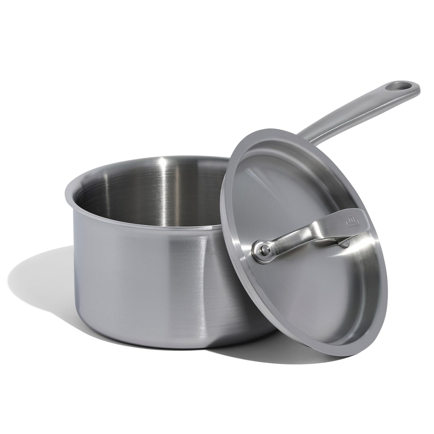 Stainless steel saucepan with lid on a white background