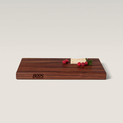 Wooden cutting board with 'BOOS' branding on a light background