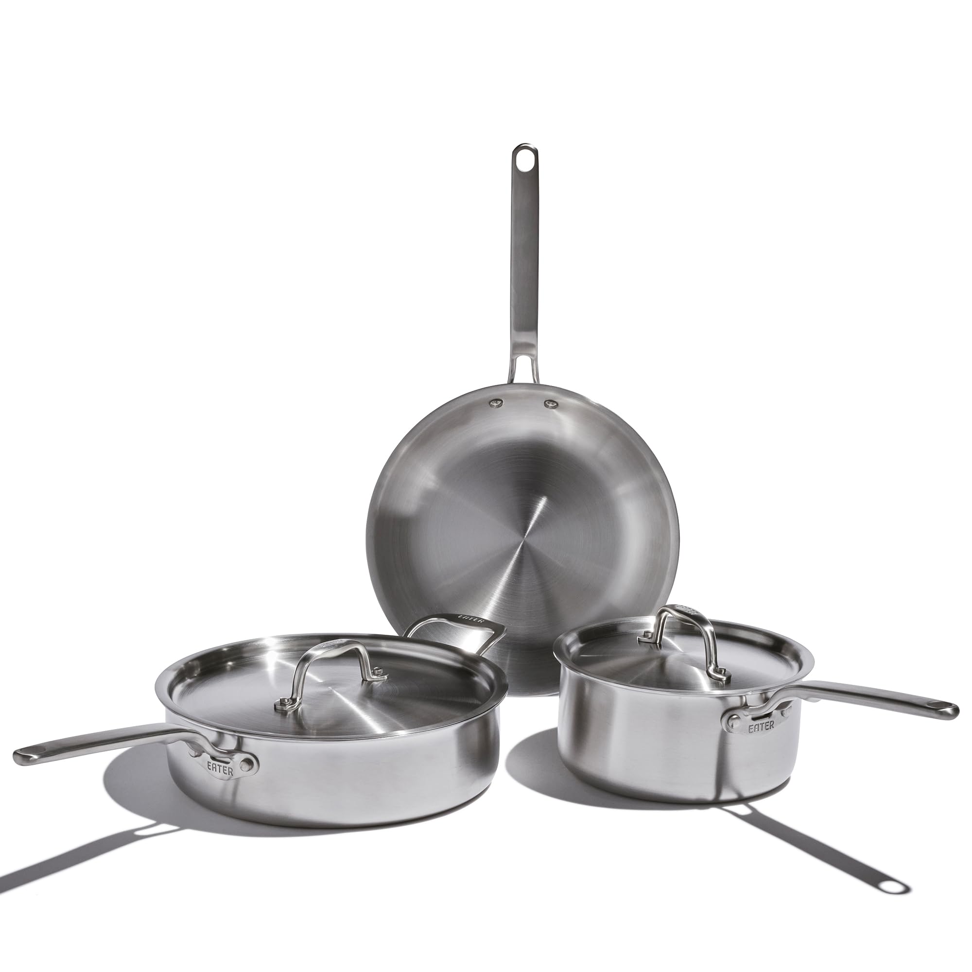 Set of stainless steel cookware on a white background