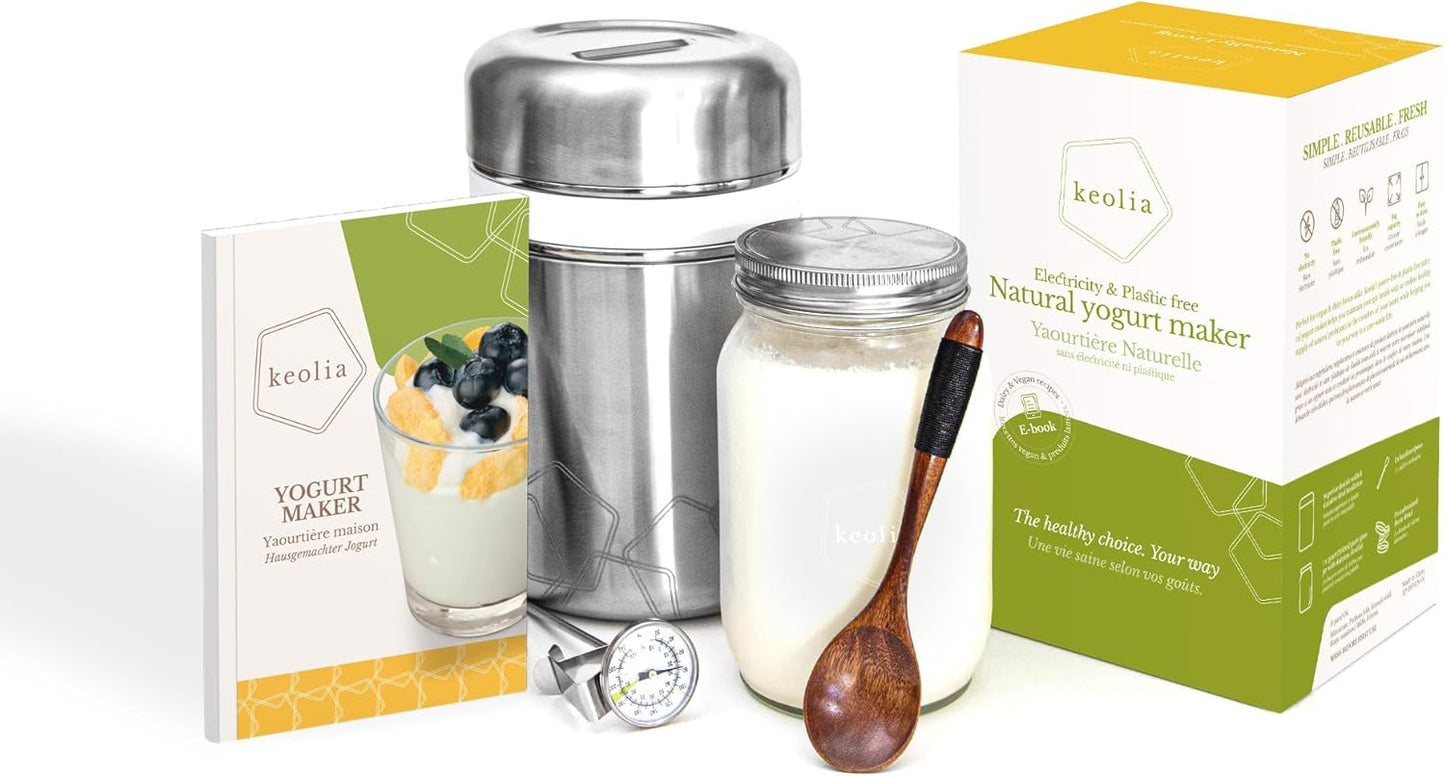 Keolia yogurt maker with packaging, jar, and wooden spoon on a white background