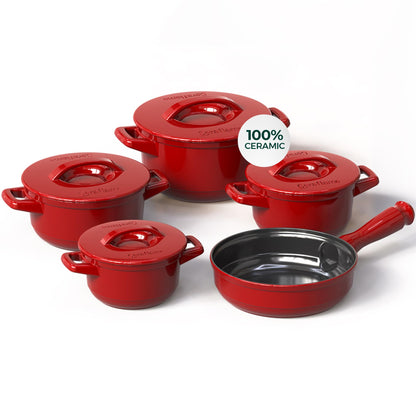 Set of red ceramic cookware with a frying pan on a white background
