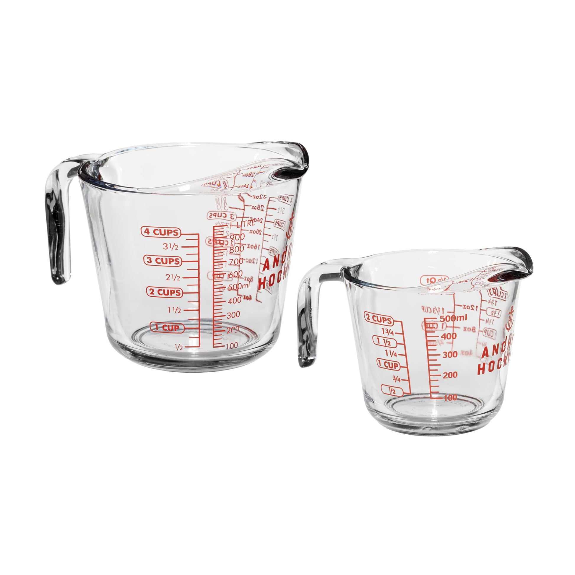 Two clear Anchor Hocking measuring cups with red measurement markings on a white background