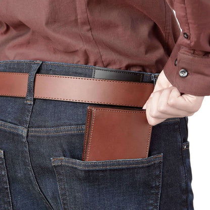 Person wearing a brown leather wallet in their jeans pocket.