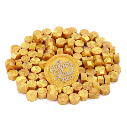 Gold-colored wax seals with 'With Love' text on a white background