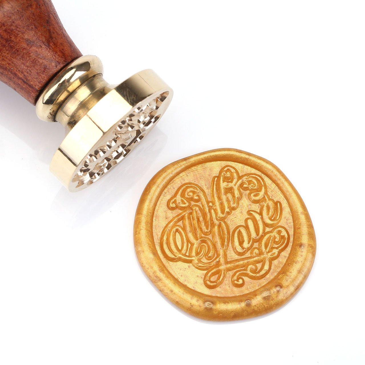 Wax seal with wooden handle and gold stamp on a white background
