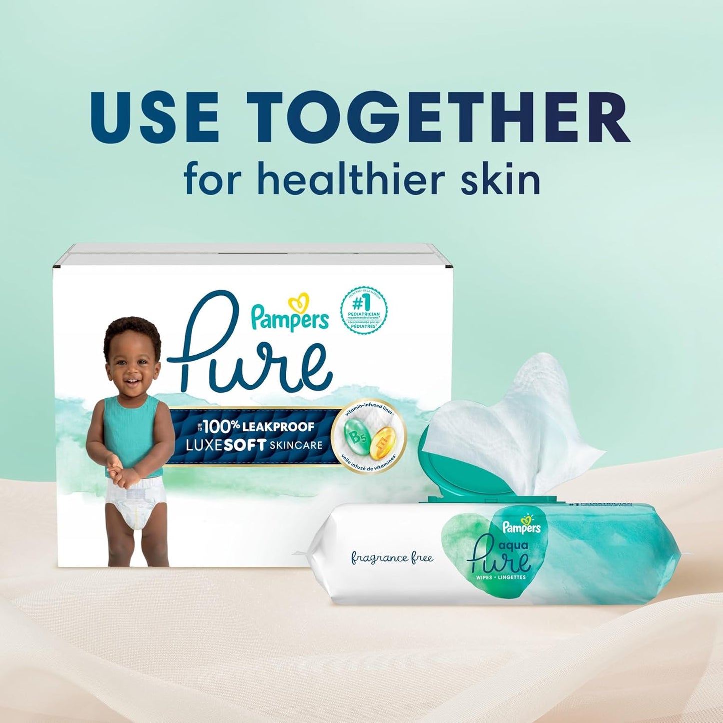 Pampers Pure diaper box with a baby and a pack of wipes on a light green background