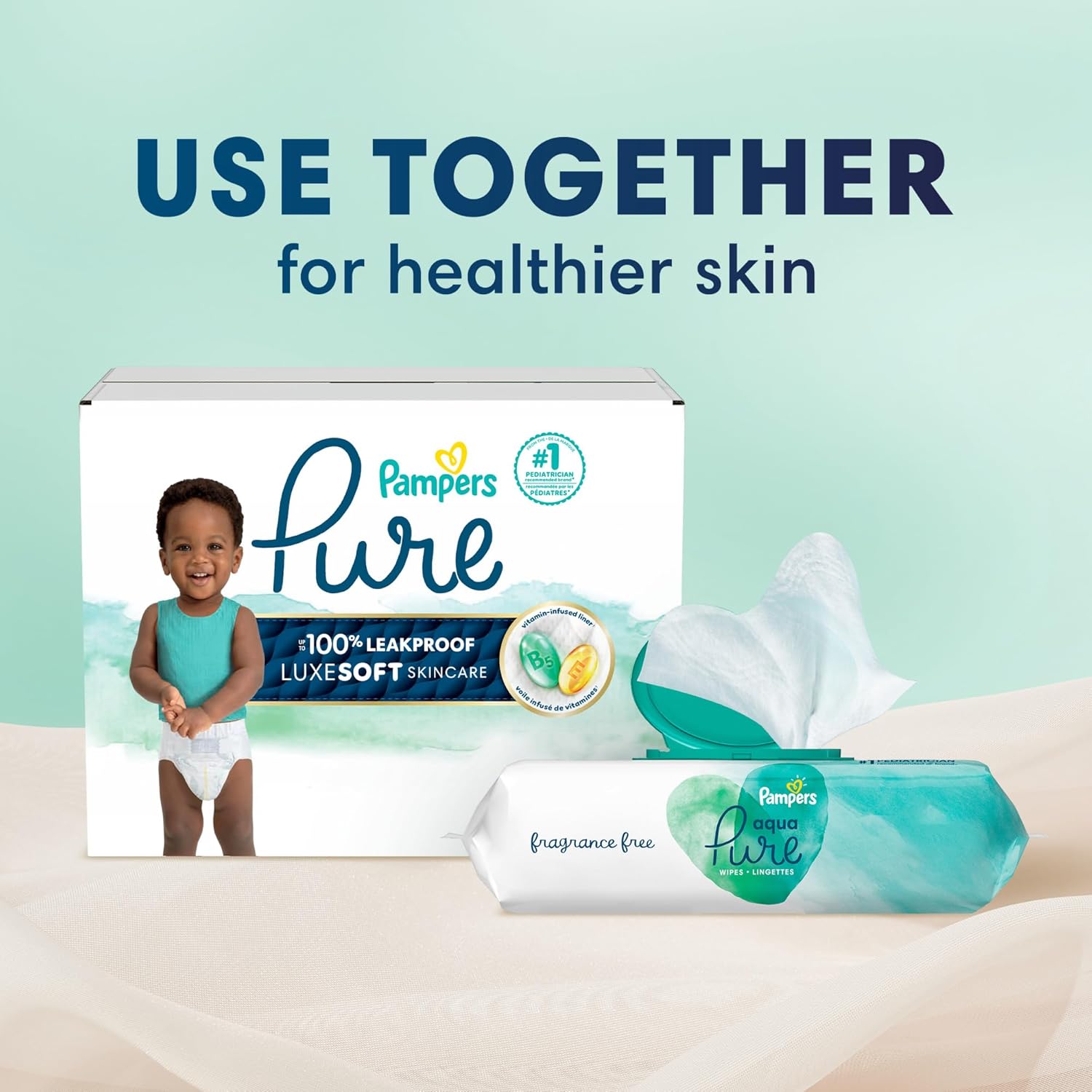 Pampers Pure diaper box with a baby and a pack of wipes on a light green background