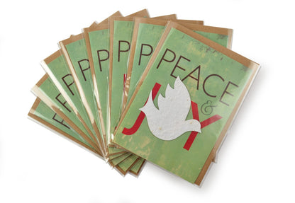 Stack of greeting cards with 'Peace' and dove design on a white background