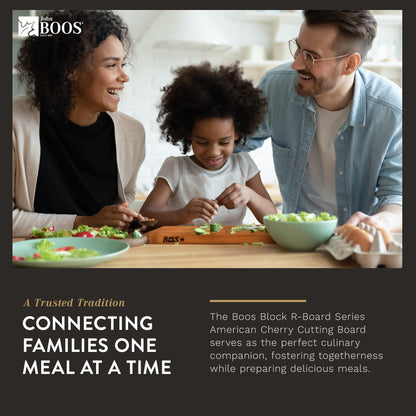 Family of three at a dining table with a Boos Block R-Board Series cutting board.