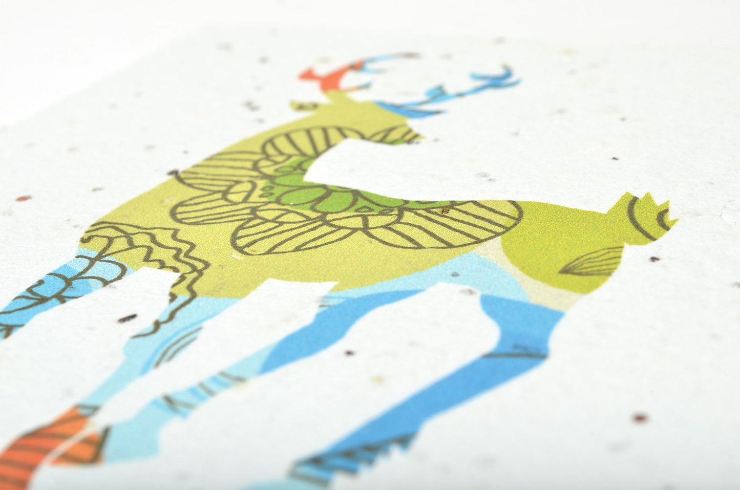 Colorful patterned fabric with a giraffe design on a white background