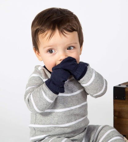 Child wearing a gray and white striped outfit with navy gloves on a plain background