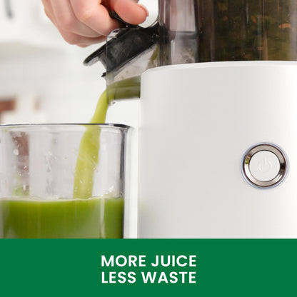 Juicer pouring green juice into a glass with a focus on efficiency.
