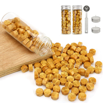 Yellow hexagonal sealing wax on a white surface with packaging and tools.