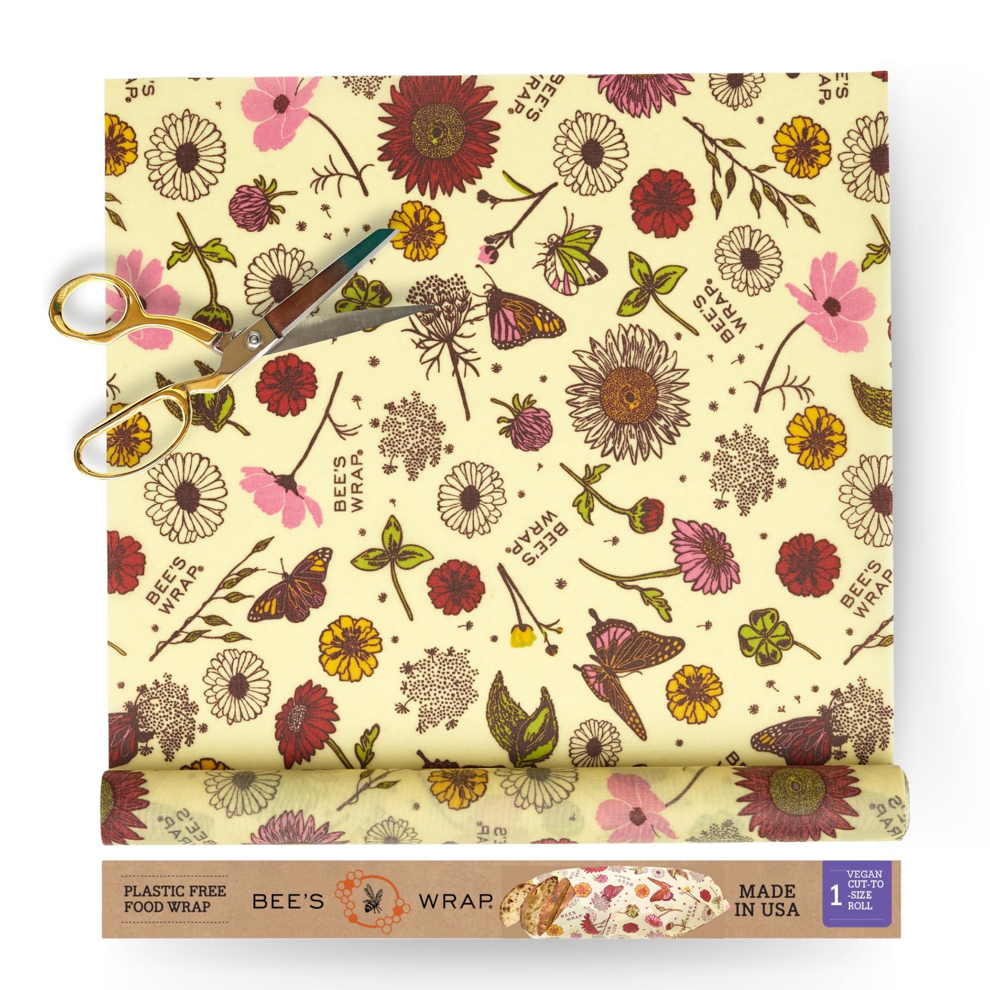 Bees wrap reusable food wrap roll of floral-patterned with scissors and packaging on a white background