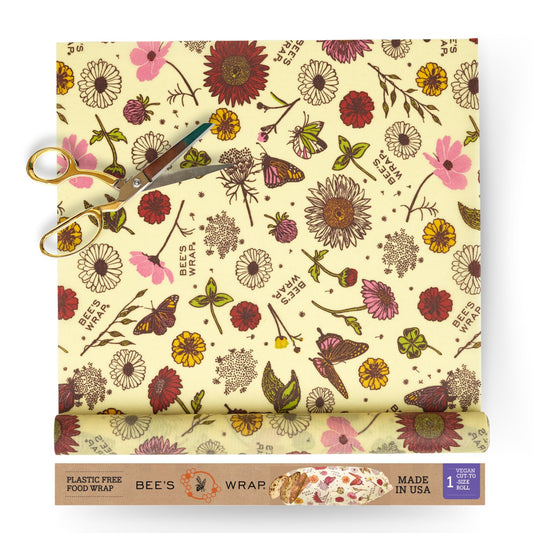 Bees wrap reusable food wrap roll of floral-patterned with scissors and packaging on a white background