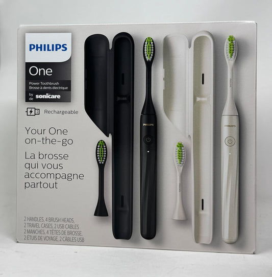 Philips One rechargeable toothbrush set in its original white retail packaging, featuring two black and two white toothbrushes with their charging cases and a travel case.