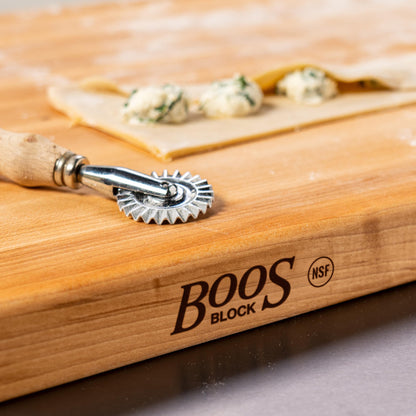 Wooden block with a metal tool on a wooden surface, featuring the 'BOOS Block' brand.