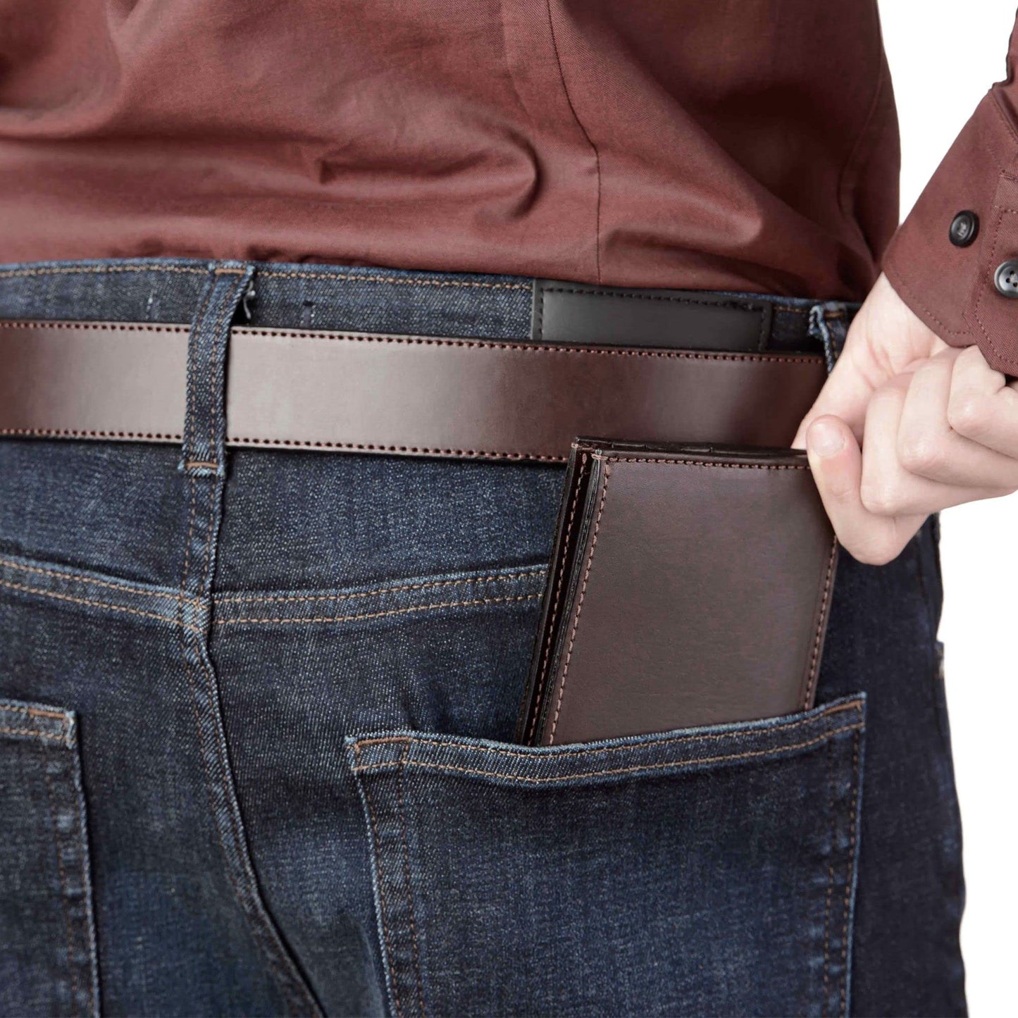 Person wearing a brown leather wallet in their jeans pocket on a white background