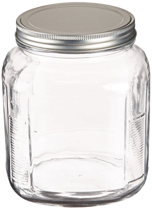 Clear glass jar with a metal lid on a white background