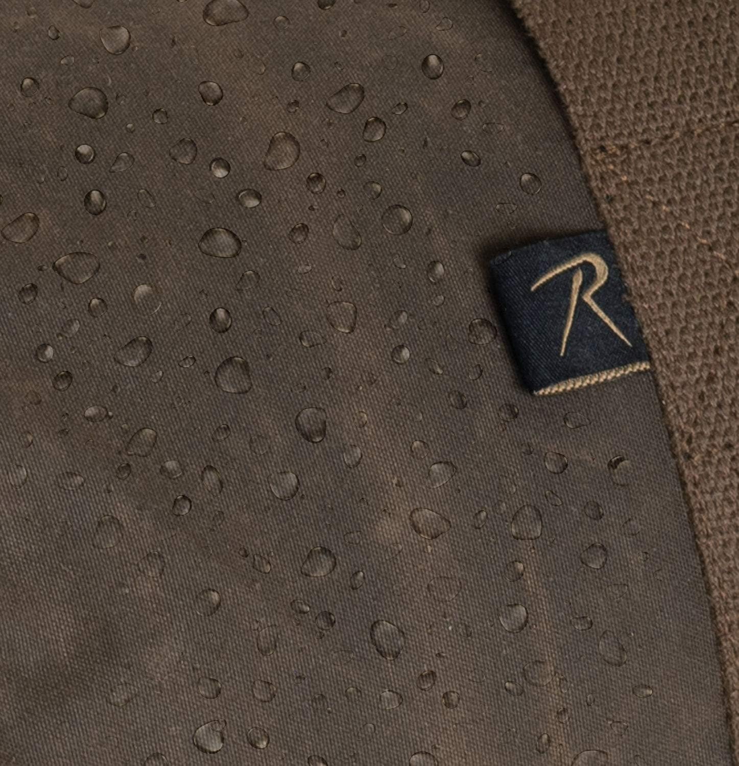 Brown fabric with water droplets and a brand logo on a dark background