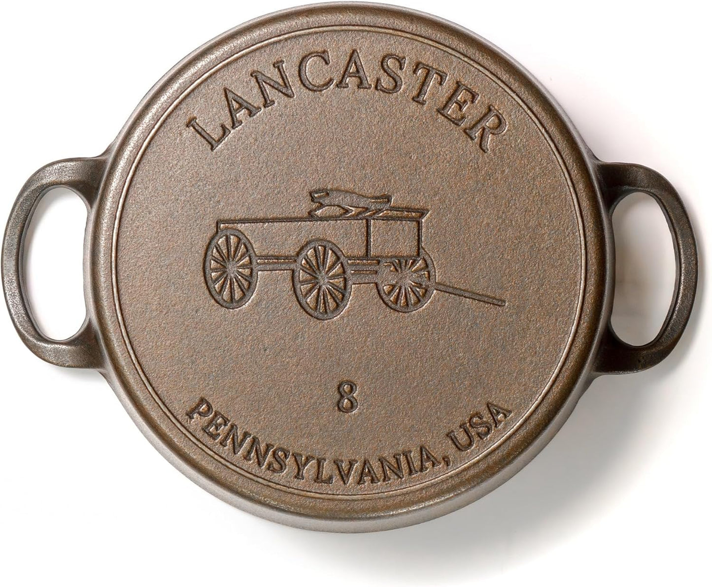 Round metal plate with 'Lancaster, Pennsylvania, USA' text and cart illustration on a white background