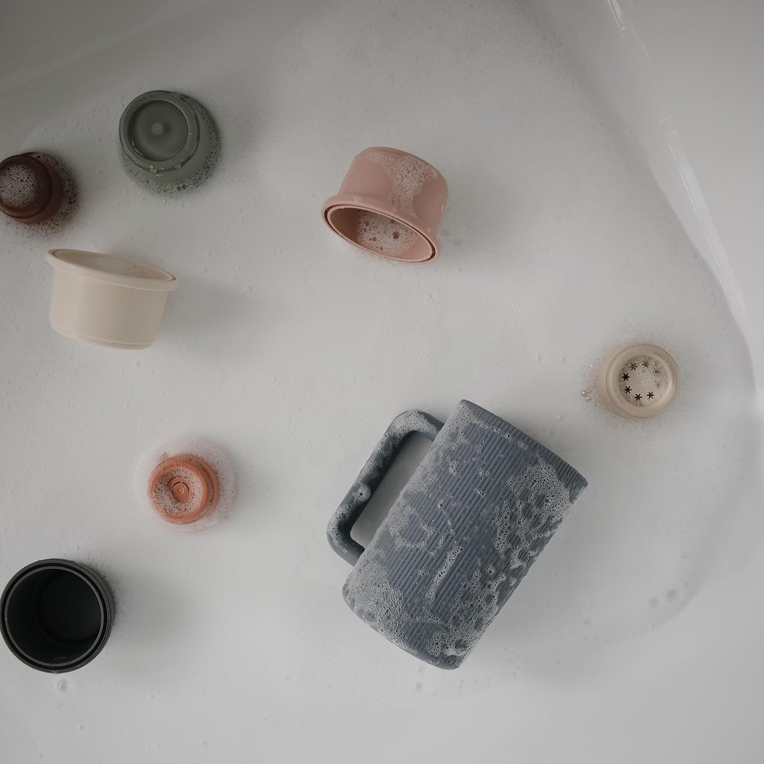 Collection of ceramic cups and bowls on a white surface