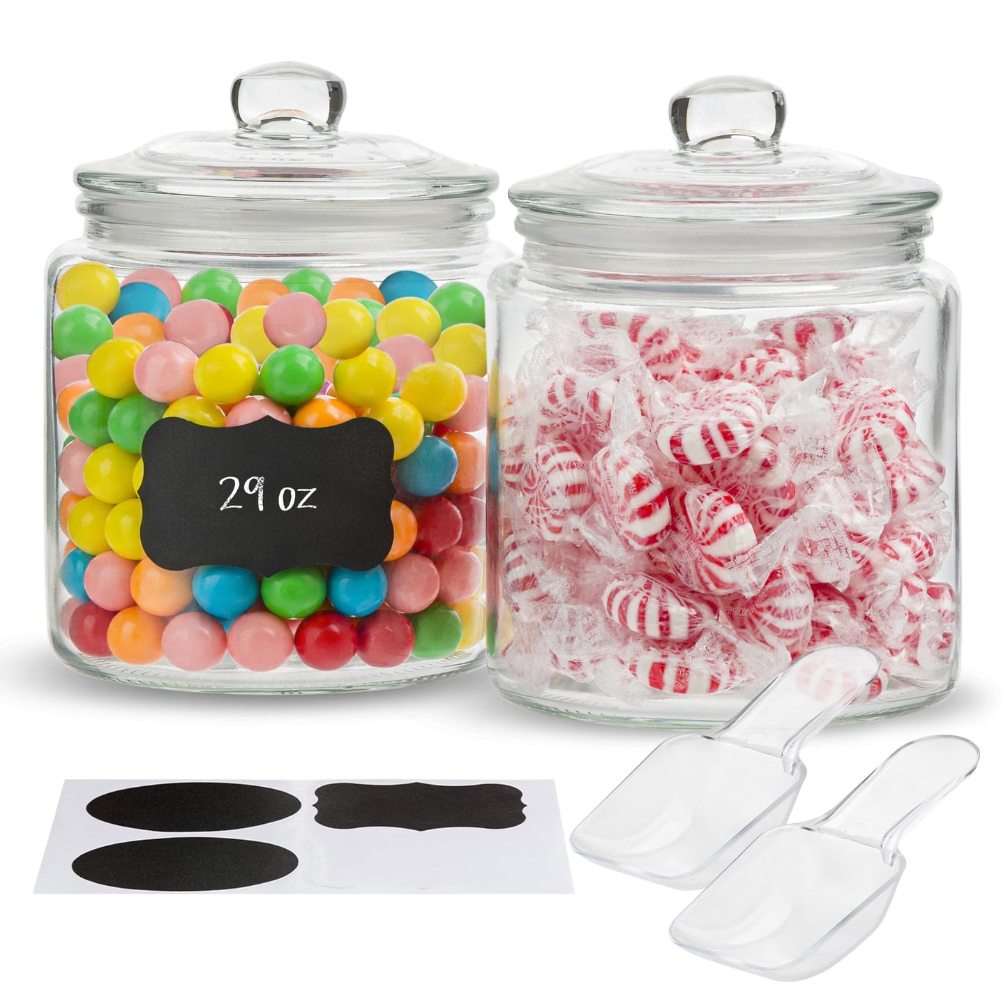 Two glass jars with colorful candies, a chalkboard label, and two clear scoops on a white background.