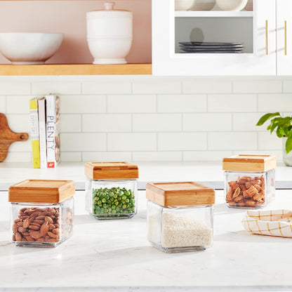 Glass storage jars with wooden lids on a kitchen counter