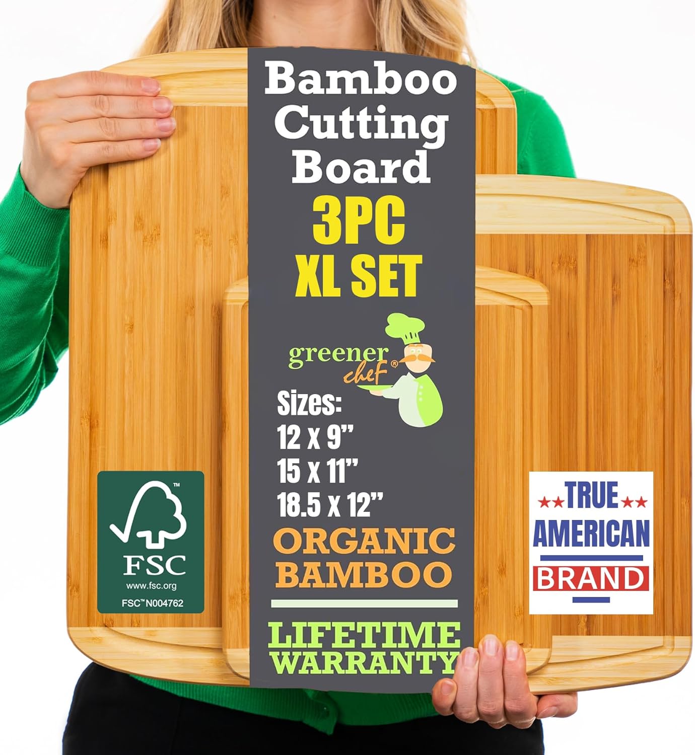 Person holding a set of three bamboo cutting boards with product details on a gray background