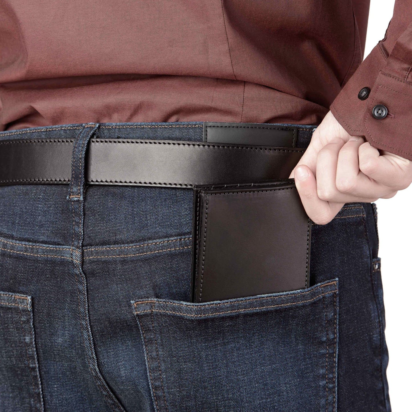 Person wearing blue jeans with a brown leather wallet in the back pocket, against a white background.
