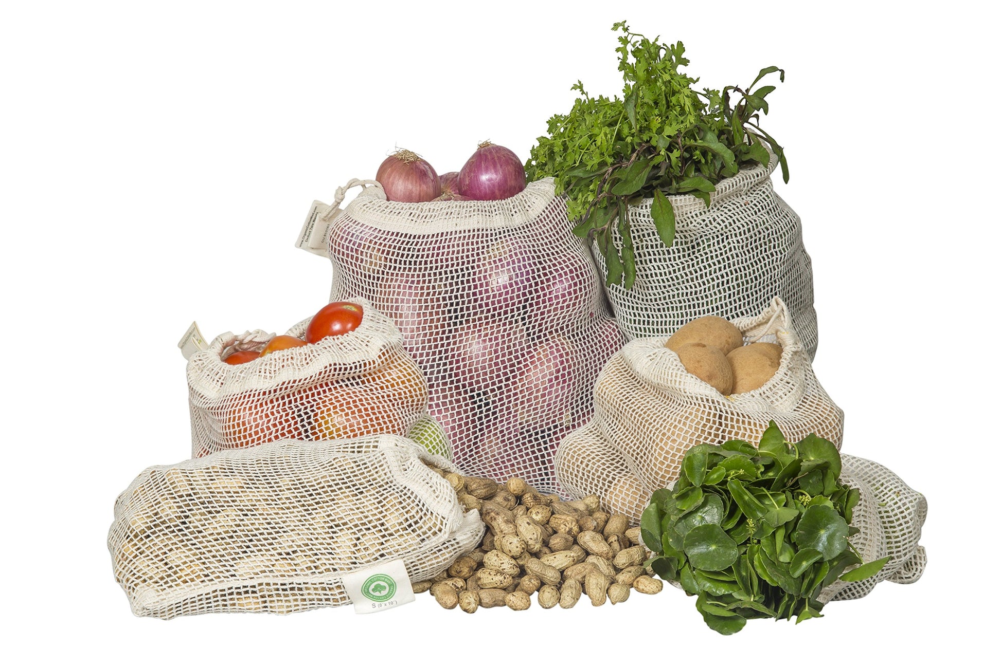 Set of reusable mesh grocery bags with vegetables and fruits on a white background
