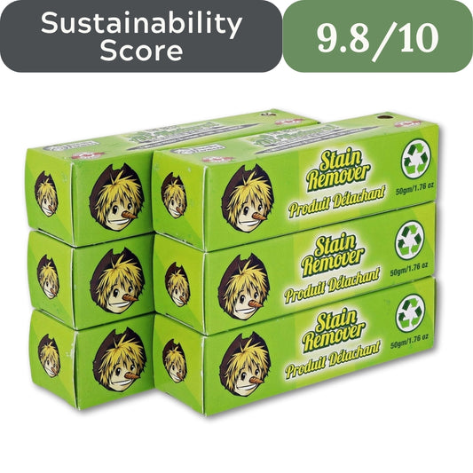 Stack of green stain remover boxes with a sustainability score label on a white background
