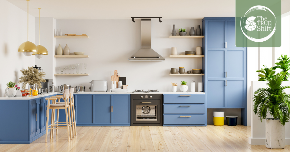 Modern kitchen with blue cabinets and wooden floors.